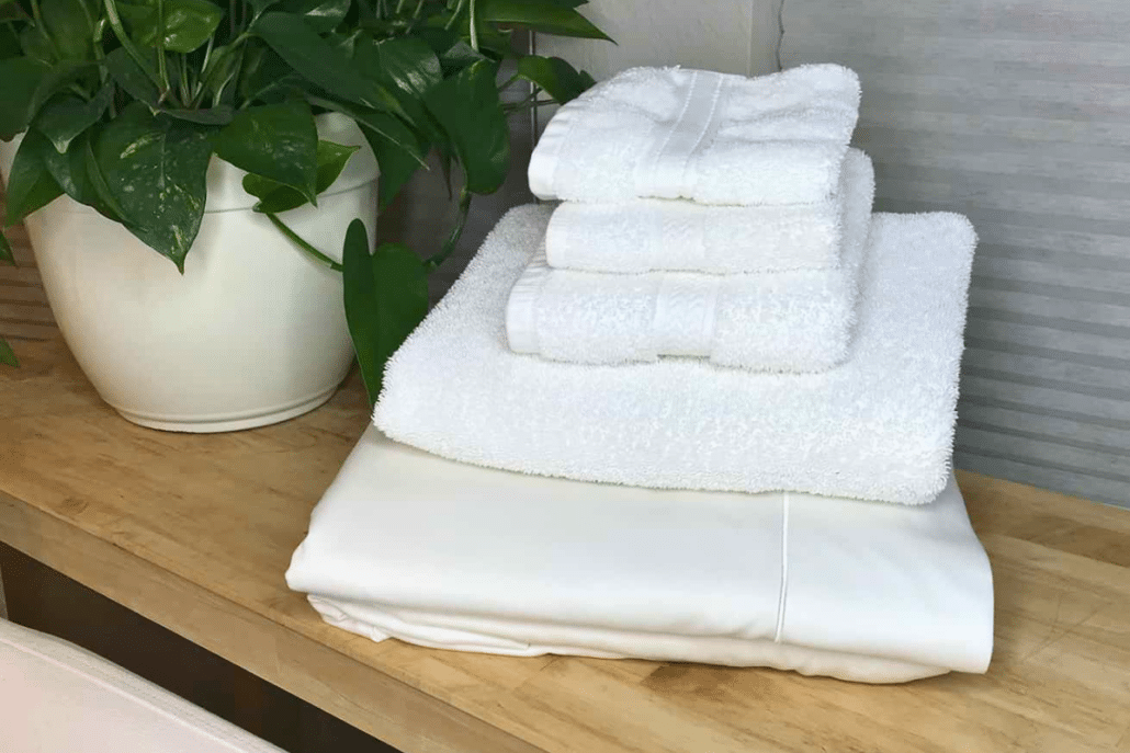 laundry stripping stack of white towels