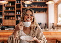 how to splurge on a budget woman drinking fancy coffee luxury treat smiling