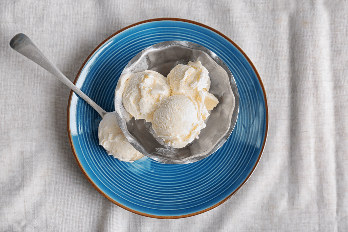 3 ingredient no churn vanilla ice cream in a bowl on a blue plate