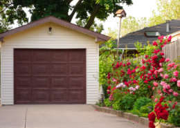 a single car garaged with beautiful flowers along landscape beds things ruined by heat in the garage