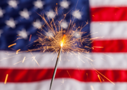 a lit sparkler with an american flag in the background 4th of july hacks tips and recipes