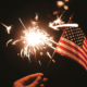 financial independence sparkler and american flag in night sky