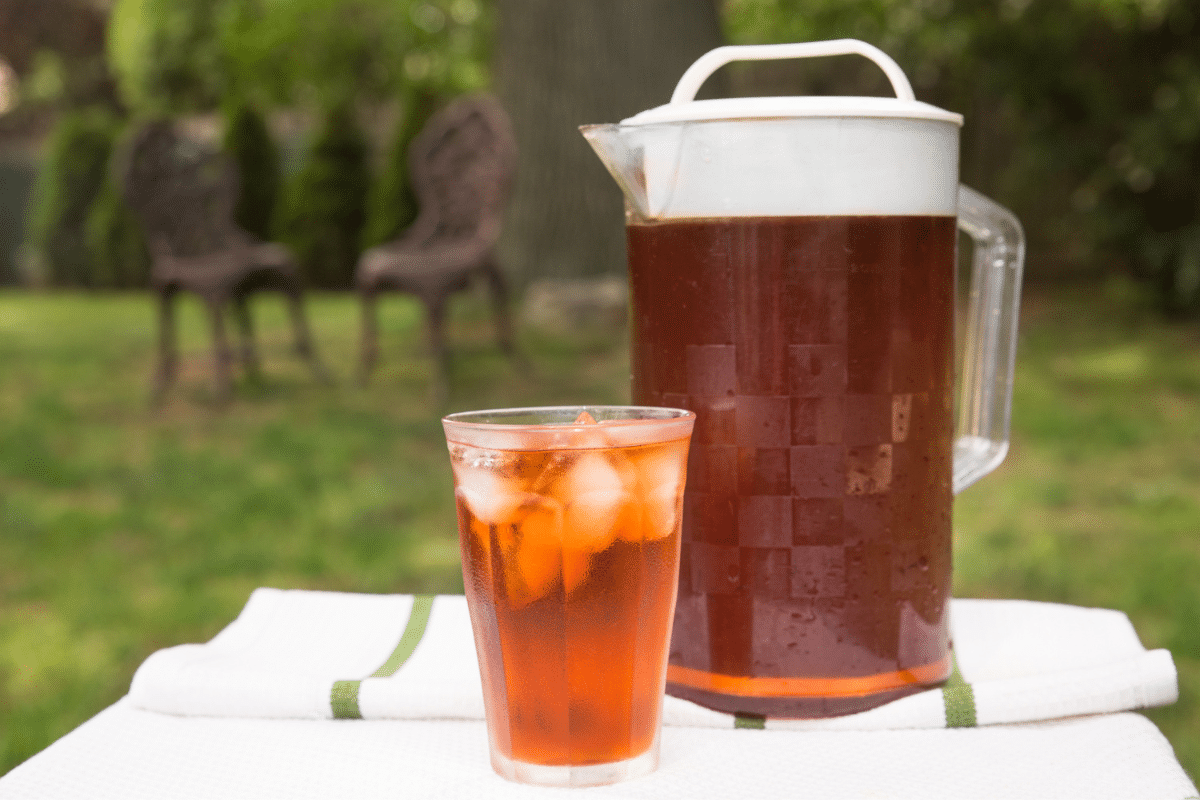 pitcher and glass of cold brew tea outside in garden