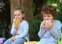 what to pack for kids lunchboxes young boy and girl eating a banana and a sandwich