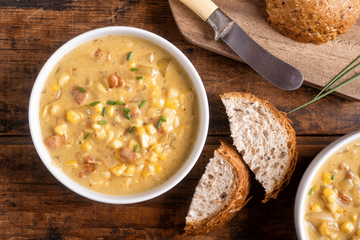 creamy corn chowder with bacon and potatoes with sliced bread