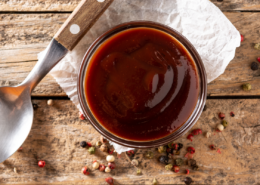 homemade bbq sauce recipe with peppercorn and a spoon