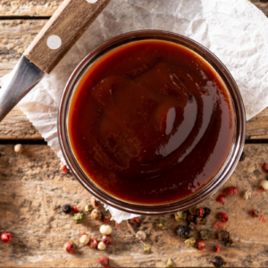 homemade bbq sauce recipe with peppercorn and a spoon