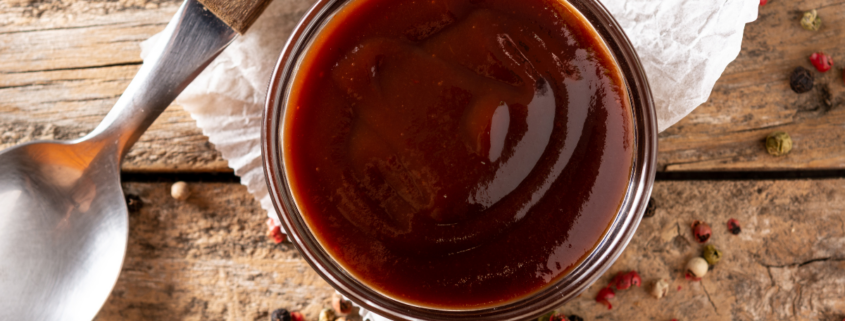 homemade bbq sauce recipe with peppercorn and a spoon