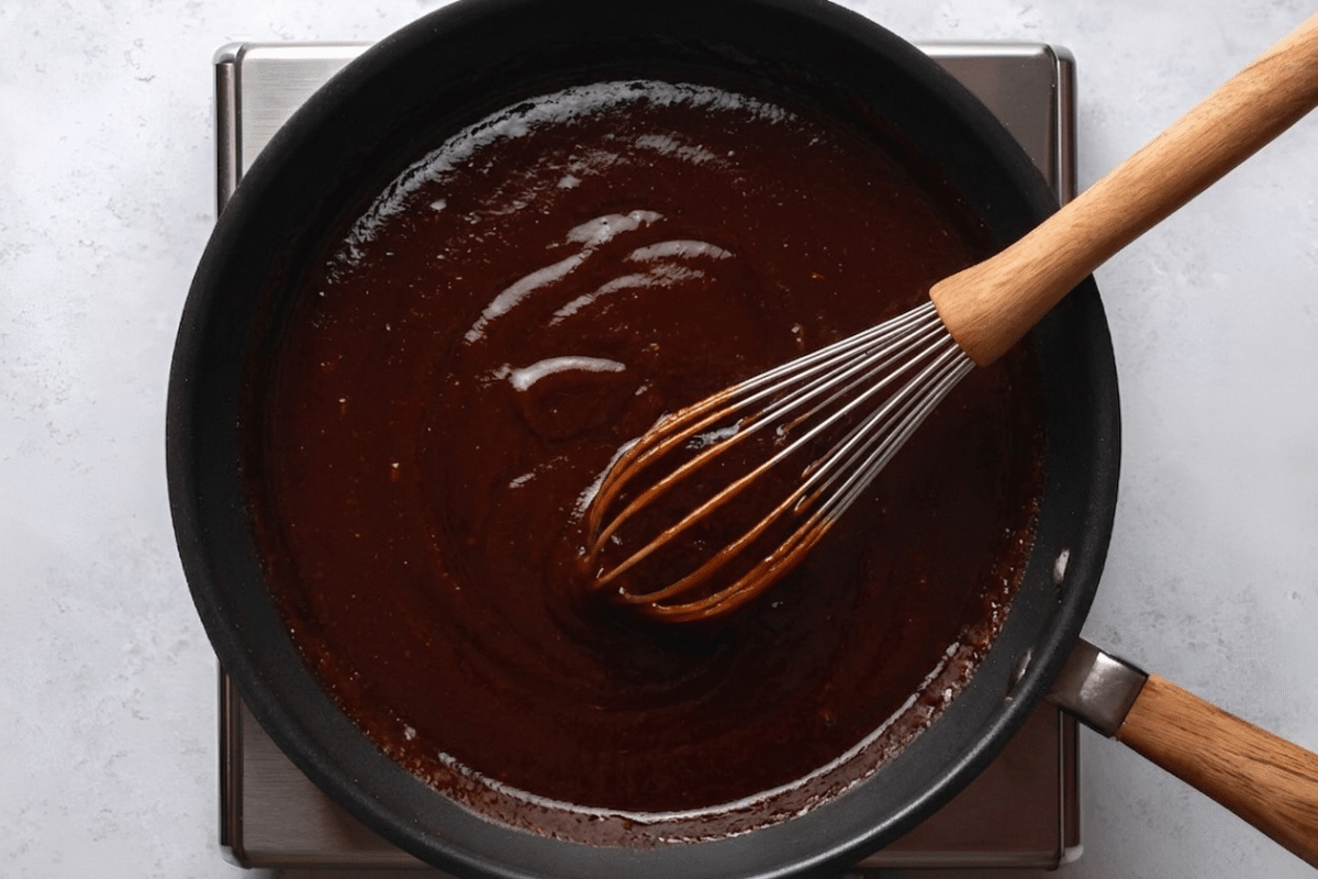 sauce pan with whisk and barbecue sauce.
