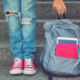 best inexpensive backpack girl holding bag with ripped jeans