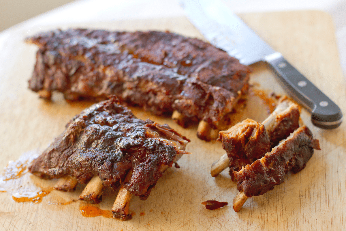separating baby back ribs on cutting board