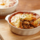 impossible lasagna pie recipe with wooden serving spoon in white casserole dish