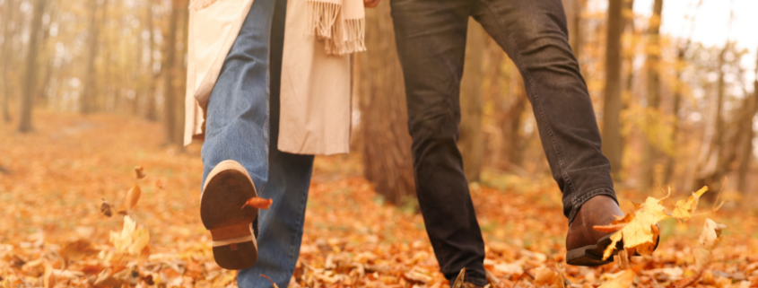 educe healthcare costs with three habits healthy couple walking in autumn leaves