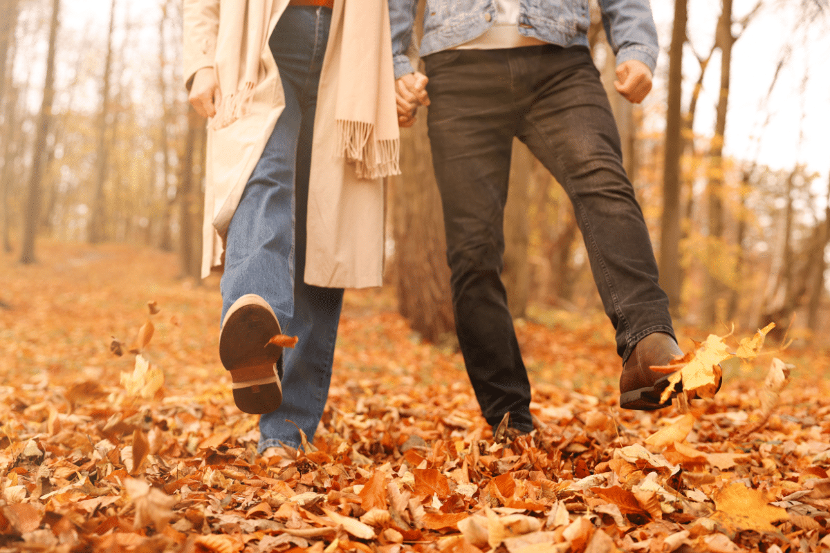 educe healthcare costs with three habits healthy couple walking in autumn leaves