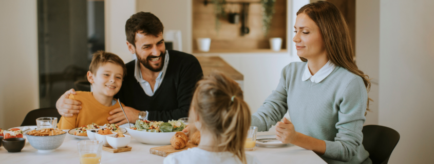 family of four eating dinner at table on a weeknight cheap easy meals