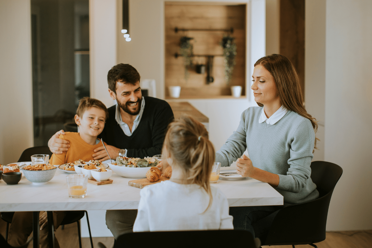 family of four eating dinner at table on a weeknight cheap easy meals