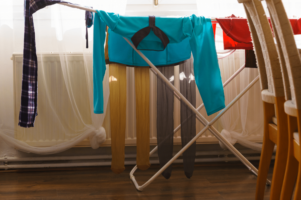 Clothes air-drying on a rack in a dining room