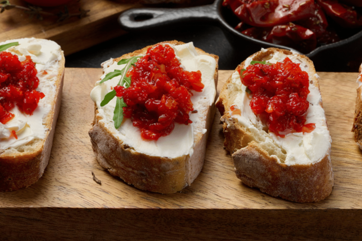 Crostini appetizer with cream cheese and red pepper and onion relish