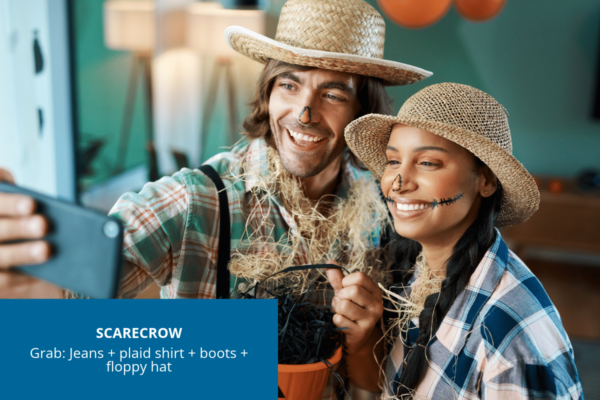 Happy couple dressed as scarecrows in jeans, a plaid shirt and floppy hat with simple face makeup