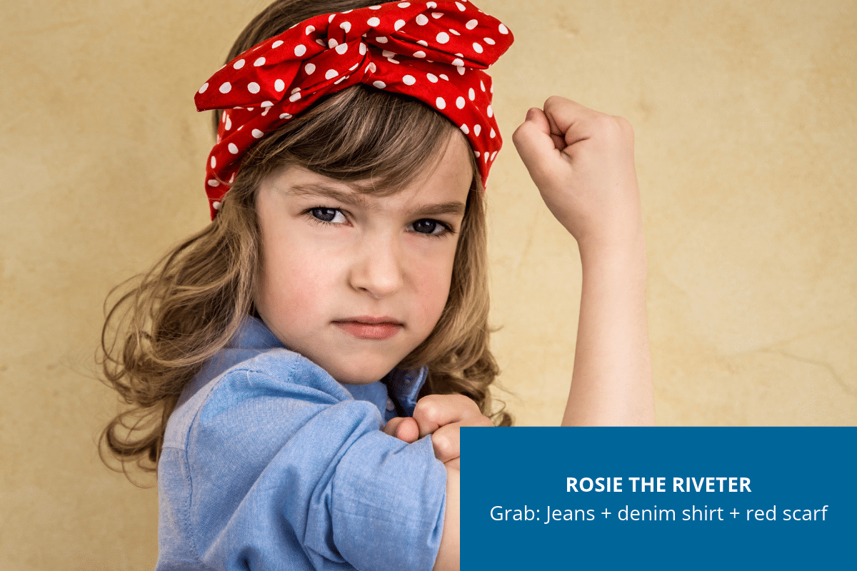Young girl dressed as Rosie the Riveter in a denim shirt and red head scarf, posing with a flexed arm