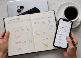 Paper calendar and digital calendar on a smartphone side by side