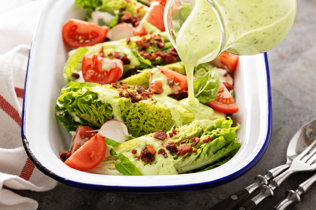 Homemade avocado dressing drizzled over a fresh green salad