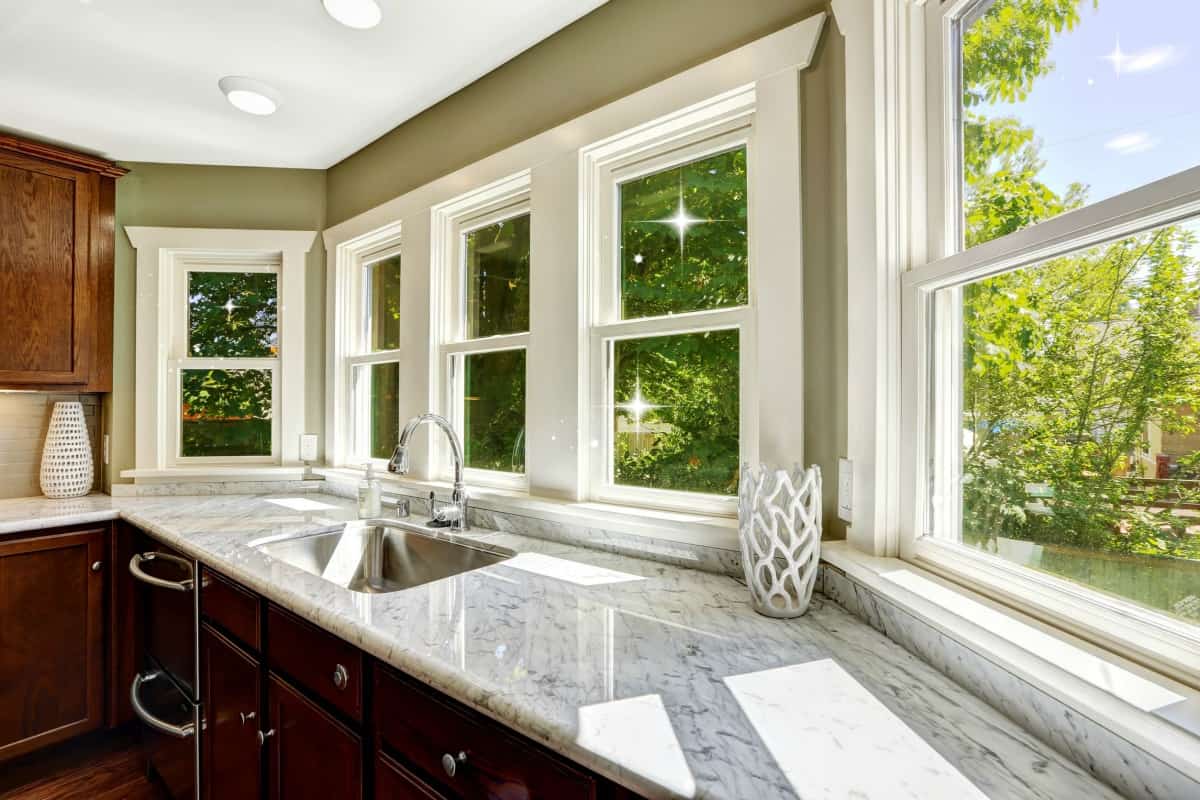 A kitchen with a sink and a large window