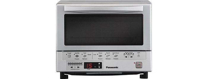 A microwave oven sitting on top of a stove