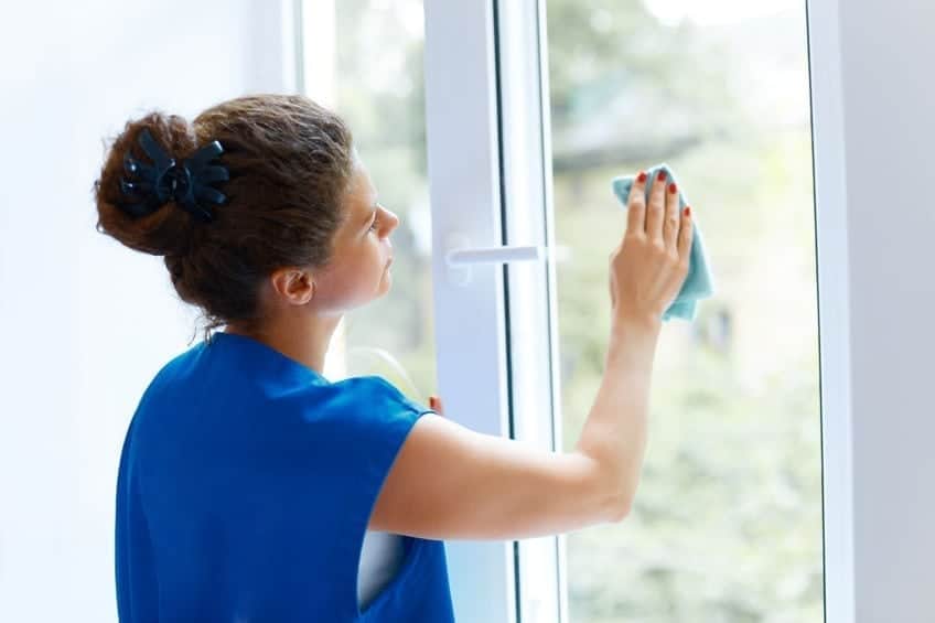A person standing in front of a window