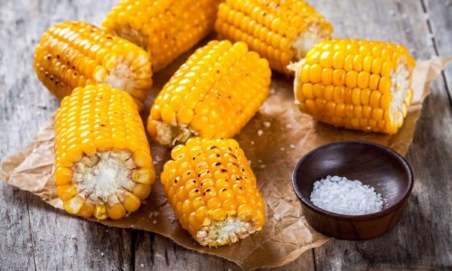 Food on a table, with Corn on the cob and Sweet corn