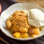 A plate of food on a table, with Cobbler and Peach