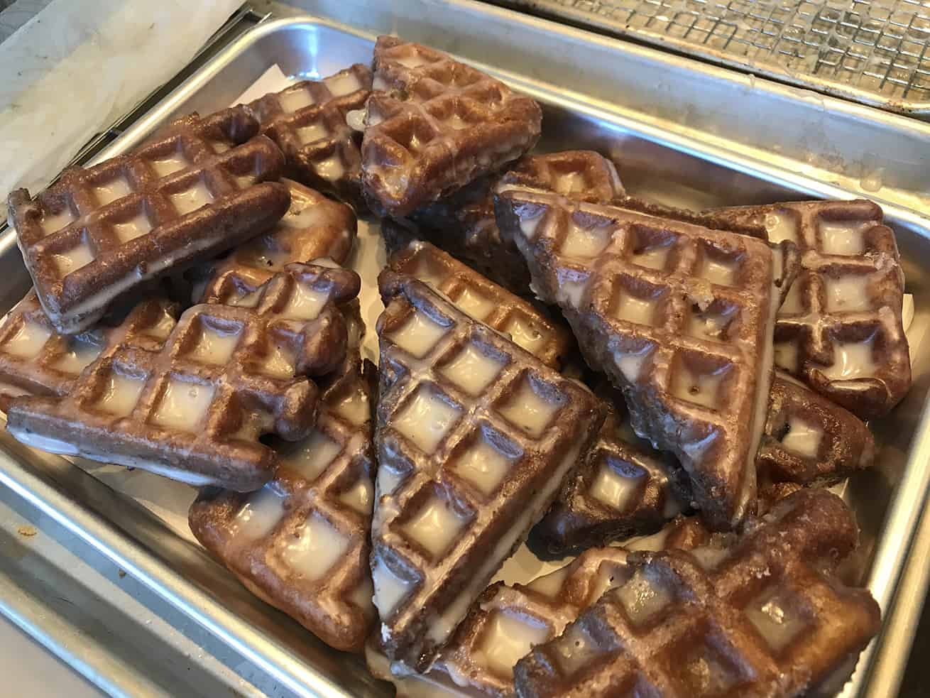 apple fritter waffle donuts hot and ready to eat on a tray