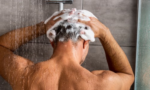 male using Blue Dawn shampoo in the shower