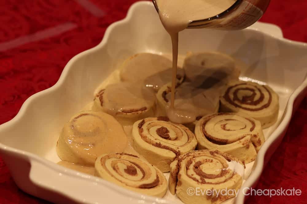 A dessert on a plate, with Cinnamon roll and Icing