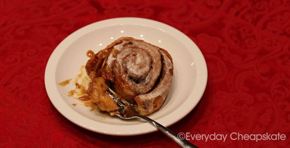 A plate of food on a table, with Cinnamon roll and Minute