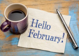 A cup of coffee on a table, with February