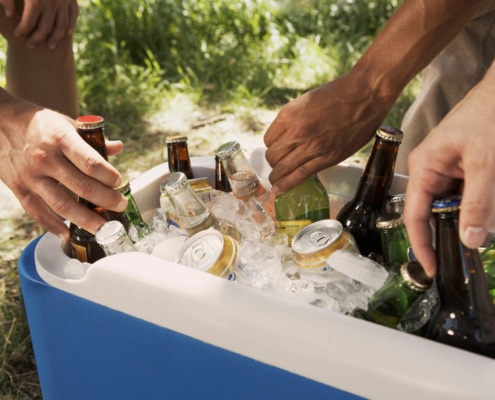 ice cooler with drinks and male hands