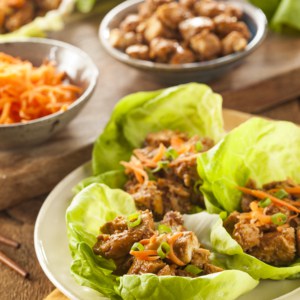 A bunch of food on a plate on a table, with Lettuce and Wrap