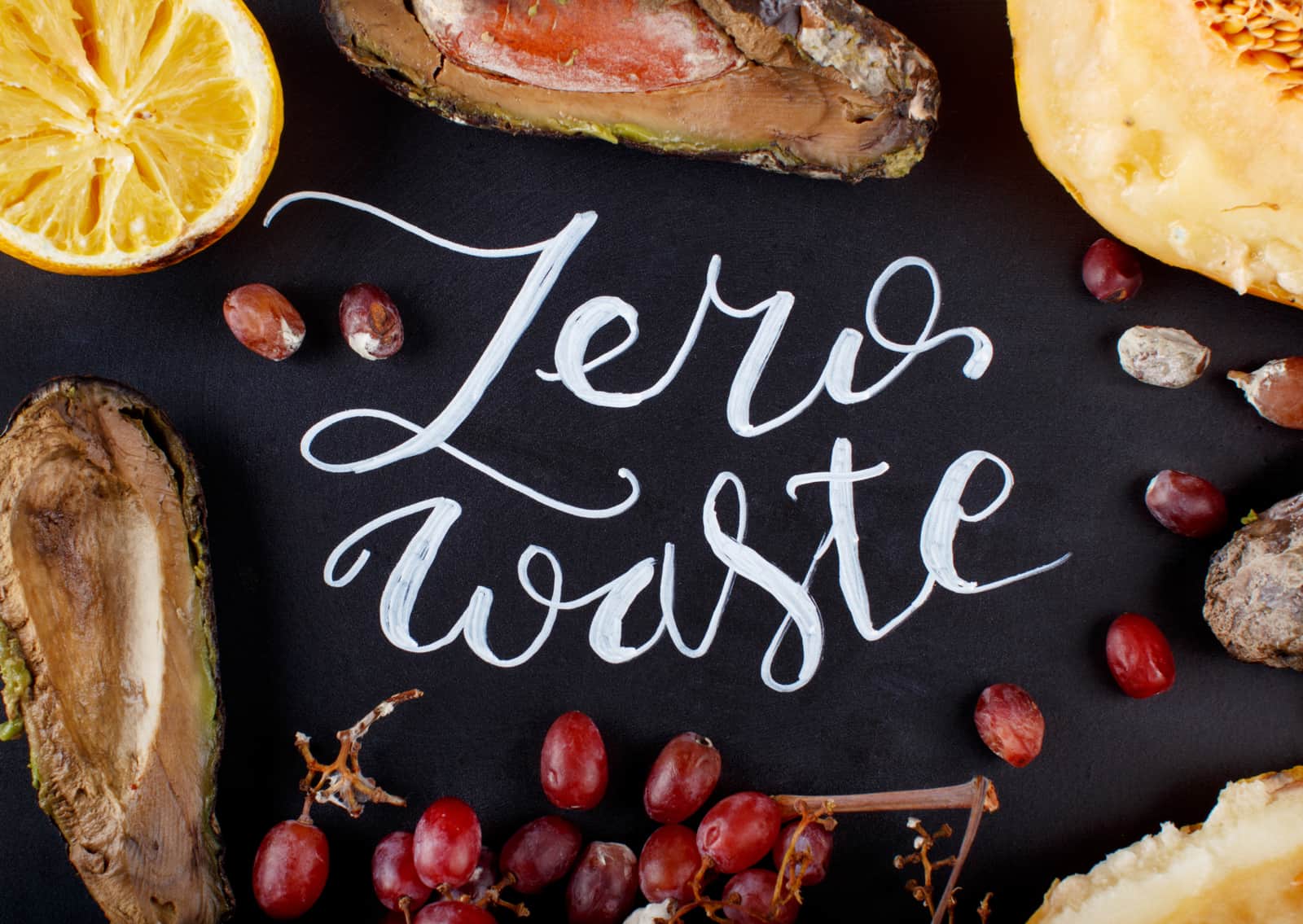 Chalkboard with zero waste lettering and rotten fruits