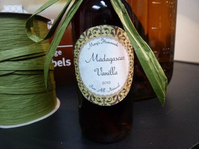 A glass bottle sitting on a table, with Gift and Vanilla extract