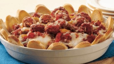 Mouth-watering, Italian meatballs, three cheeses on a platter rimmed by toasted slices of French bread