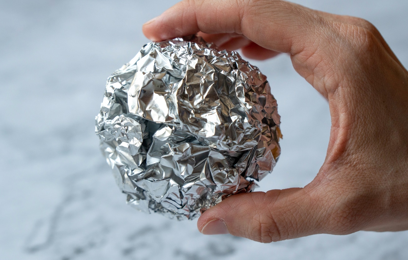 Wrinkled ball of aluminium foil, a material often used in the kitchen.