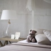 A teddy bear sitting on top of a bed