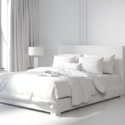 white bedding on white bed in white room