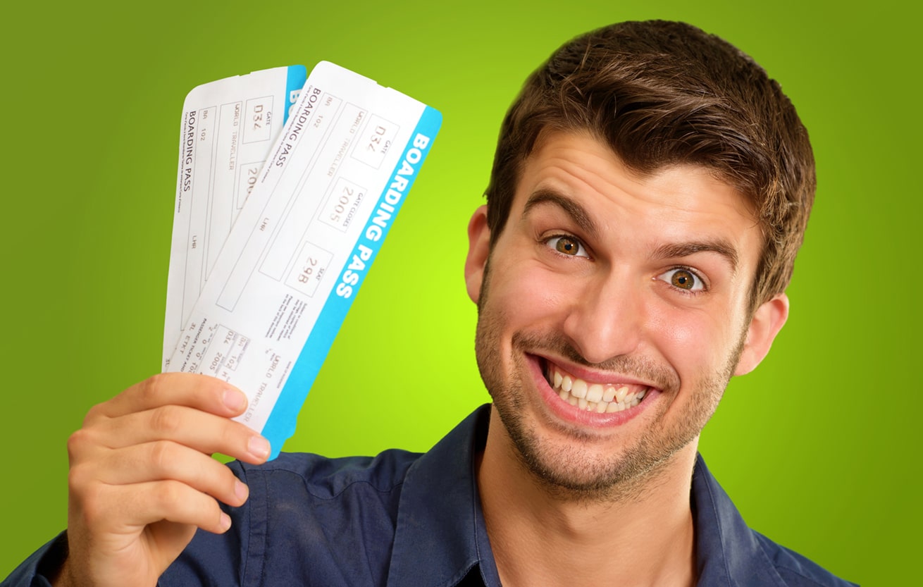 A Young Man Holding Tickets On Green Background