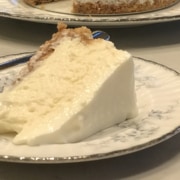 A piece of cake on a plate, with Cheesecake