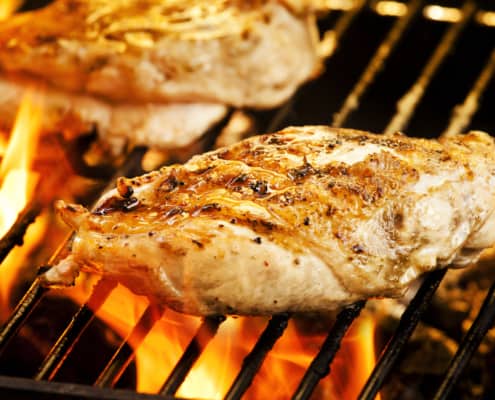 A close up of food on a grill, with Chicken breast
