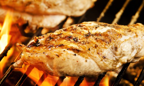 A close up of food on a grill, with Chicken breast