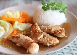 a plate of dump chicken with rice and vegetables.