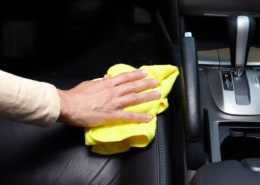 hand cleaning car interior